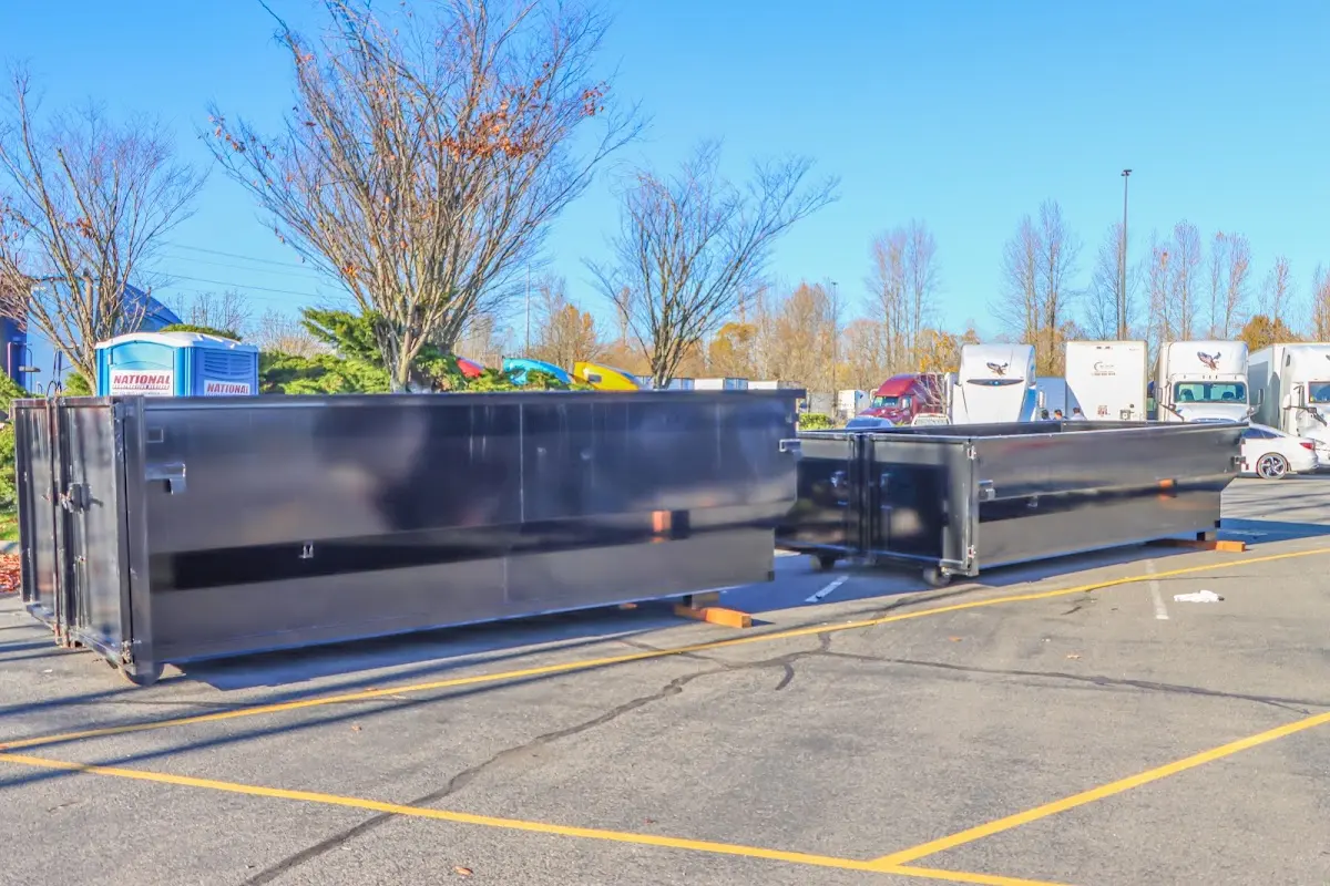 Professional dumpster rental service with roll-off container on residential driveway in Petal